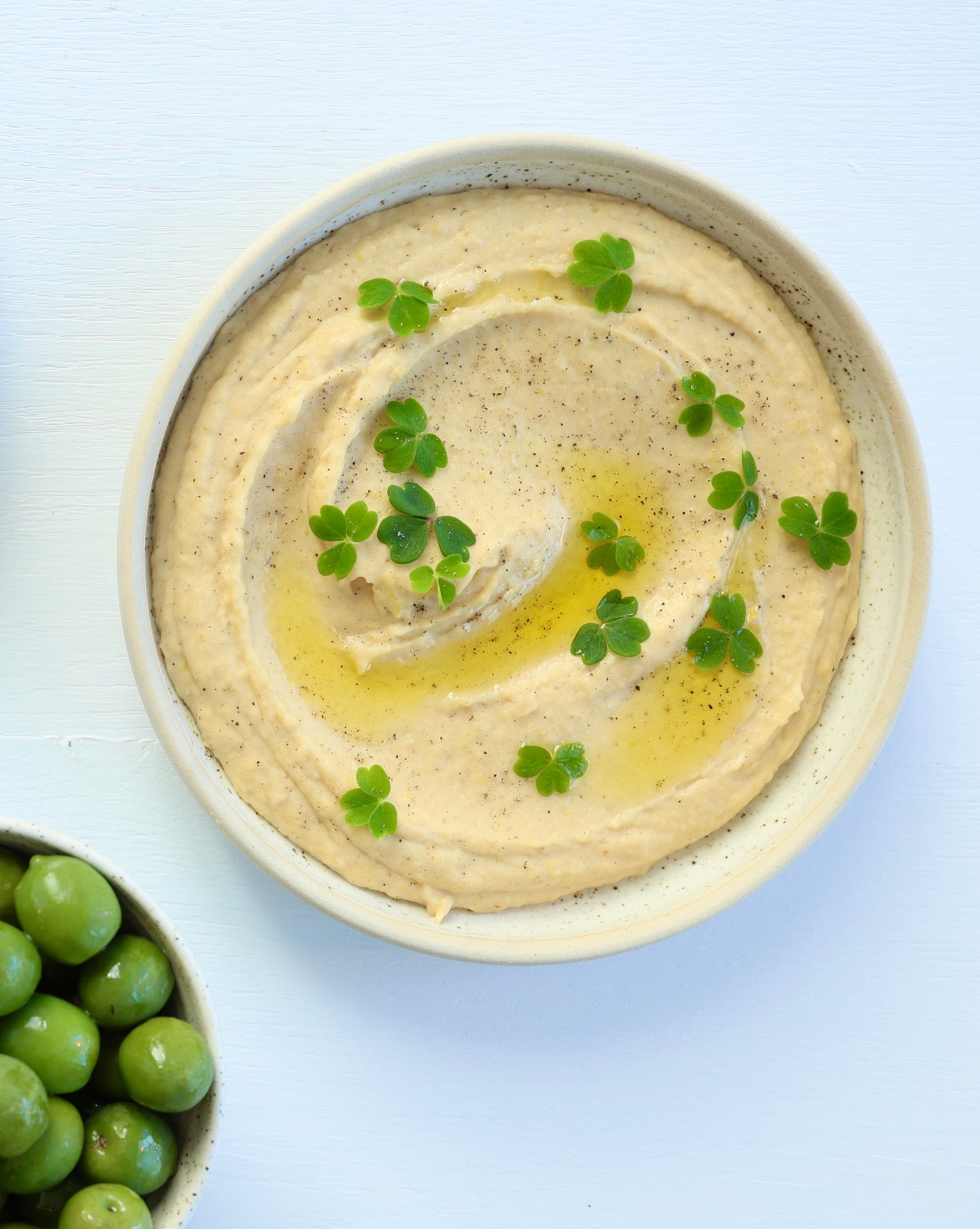 Bowl of silky lemony butter bean purée drizzled with olive oil and lemon zest